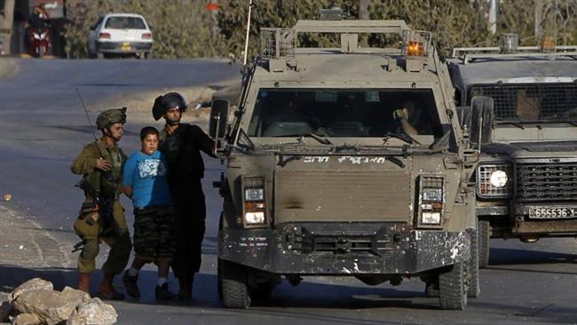 In this file photo, Israeli soldiers are seen arresting a Palestinian teenager during a protest against the expropriation of Palestinian land by Israel and the construction of a separation wall in Salwad village, eastern Ramallah, occupied West Bank.