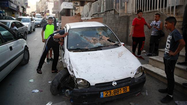 People look at the car of Palestinian Mustafa Nimr, who was killed by Israeli forces in Shuafat refugee camp in East Jerusalem al-Quds on September 5, 2016. ©AP