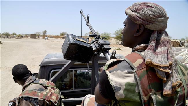 This May 25, 2015 file photo shows soldiers patrolling a road between Diffa and Bosso in the southeast of Niger near the border with Nigeria. (Photo by AFP)

