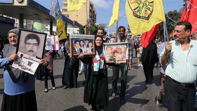 Palestinian women hold portraits showing images of relatives, who were killed during the Sabra and Shatila massacre, at a march to mark the 34th anniversary of the tragedy in Beirut, Lebanon, September 16, 2016