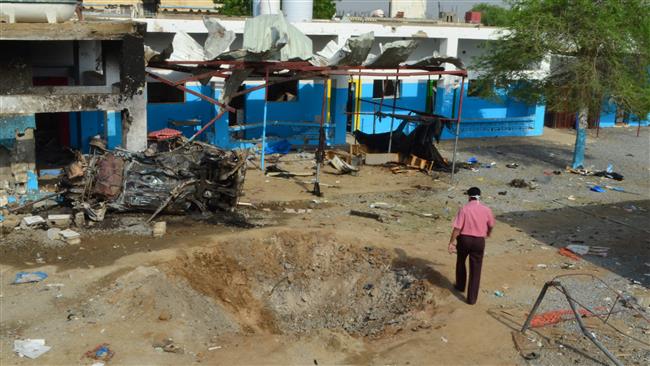 This file photo taken on August 16, 2016 shows a Yemeni man walking past a crater in the courtyard of a hospital operated by the international medical charity Médecins Sans Frontières (MSF) in Abs district of the northern Yemeni province of Hajjah, a day after the hospital was hit by a Saudi air strike. (Photo by AFP)
