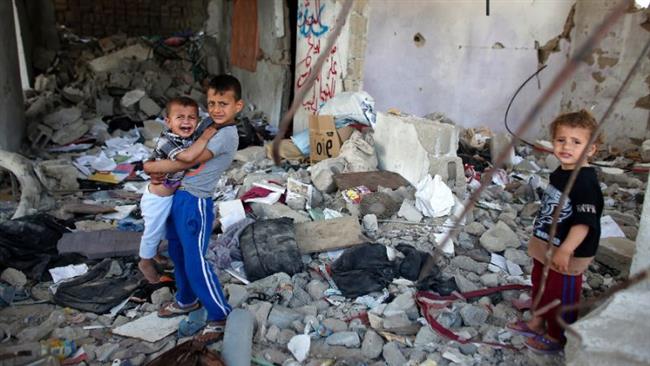 Palestinian children stand amid the rubble of their partially-rebuilt house, which was destroyed during the 2014 50-day Israeli war on Gaza, May 11, 2015.
