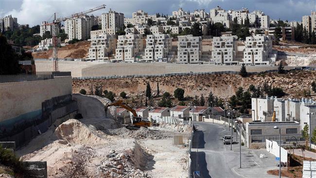 A general view taken on September 23, 2016, shows Israeli construction cranes and excavators at a building site of new housing units in the settlement of Neve Yaakov, the northern area of East Jerusalem al-Quds. (Photo by AFP)
