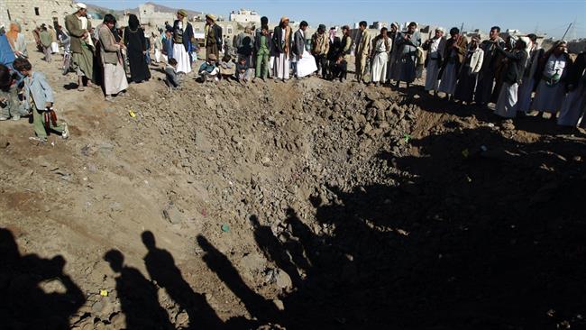 Yemenis gather around a crater caused by a Saudi airstrike on the outskirts of the capital Sana’a on December 29, 2015. (Photos by AFP)