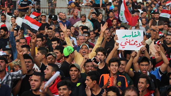 Supporters of Iraqi cleric Moqtada al-Sadr chant slogans and wave national flags during a demonstration in Baghdad