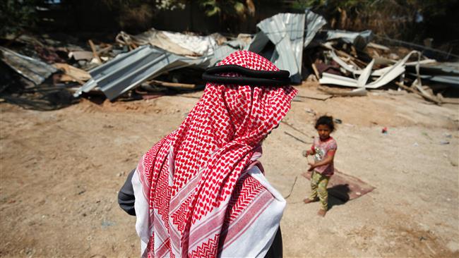 A Palestinian stands facing the debris of his house destroyed by Israeli forces in the occupied West Bank, April 7, 2016. (Photo by AFP)
