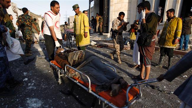 Yemeni rescue workers carry a victim on a stretcher in the aftermath of a Saudi airstrike against a packed funeral site in the Yemeni capital, Sana’a, October 8, 2016. (Photo by AFP)
