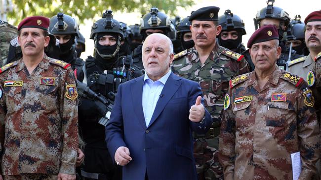 The photo released on July 9, 2016, by the office of Iraqi Prime Minister Haider al-Abadi shows him (C) posing for a picture with army generals and members of the counter-terrorism forces in the capital Baghdad. (Photo by AFP)
