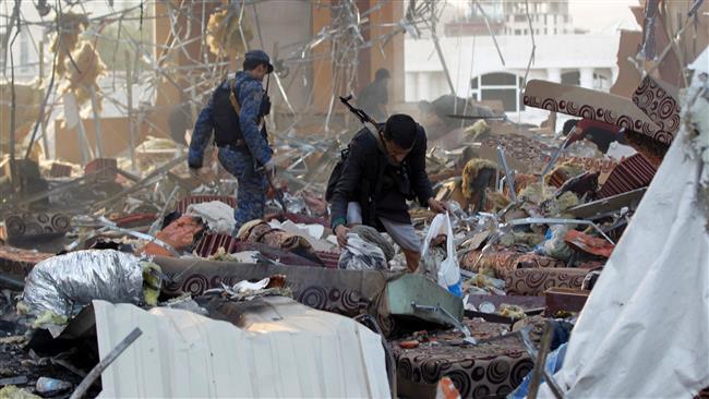 A Yemeni collects data-x-items amidst the rubble of a destroyed building following Saudi airstrikes on the capital Sana’a, on October 8, 2016. (Photo by AFP)
