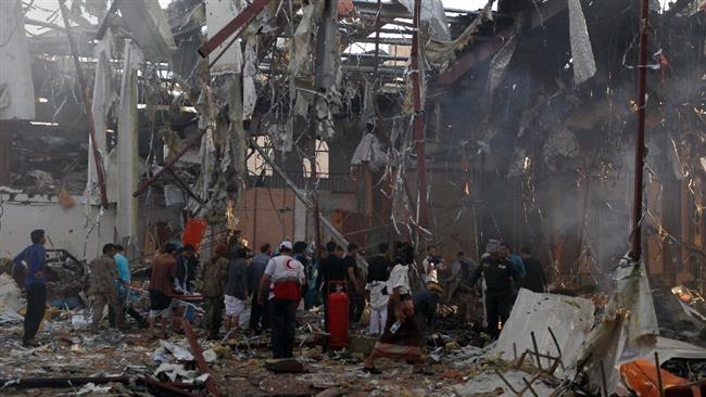 Rescue teams and bystanders gather at the site of a Saudi airstrike on a funeral hall in the capital Sana