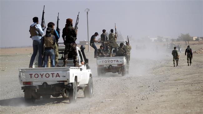 Militants drive their vehicles towards A