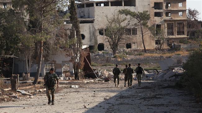 Syrian pro-government soldiers patrol the area of Awijah as they advance in Aleppo