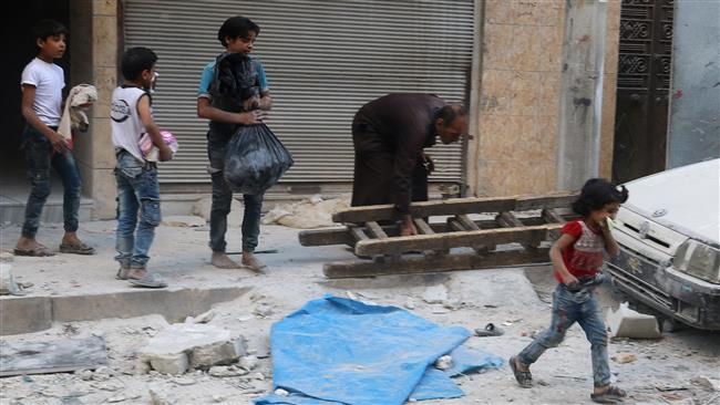 Children react in a damaged site after an airstrike in the al-Qaterji neighborhood of Aleppo, Syria, October 14, 2016. (Photo by Reuters)