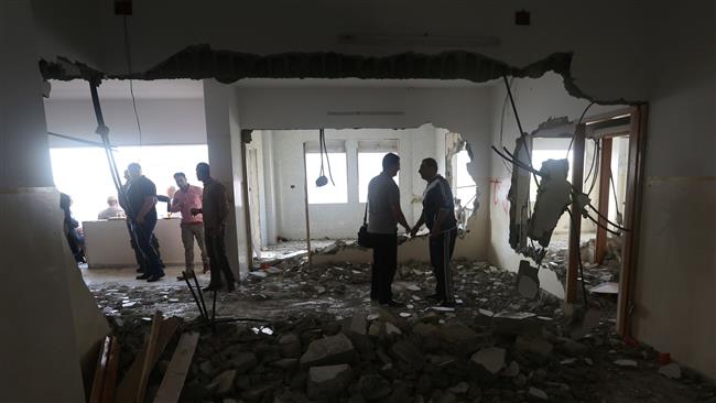 Palestinians check the flat of Amjad Aliwi after Israeli authorities demolished it in the northern occupied West Bank city of Nablus on October 11, 2016. (Photo by AFP)
