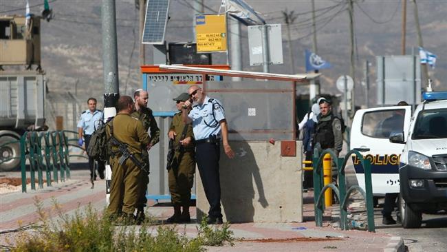 Israeli security forces gather at the site where a Palestinian woman was shot dead by regime’s military, near the Tapuah junction, also known as the Zaatara junction, south of the city of Nablus in the Israeli occupied West Bank, on October 19, 2016. (Photo by AFP)