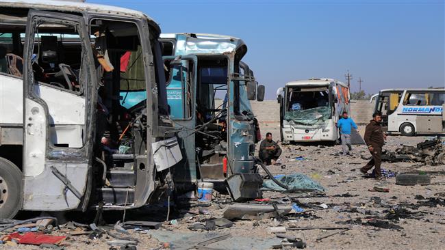 People gather at the site of a blast where a terrorist blew up his explosives-laden vehicle in Iraq