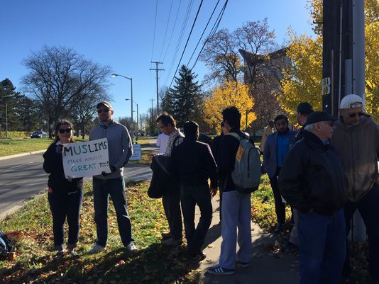 Half a dozen East Lansing community members stood in front of the Islamic Center of East Lansing to show support amid rumors of protest 