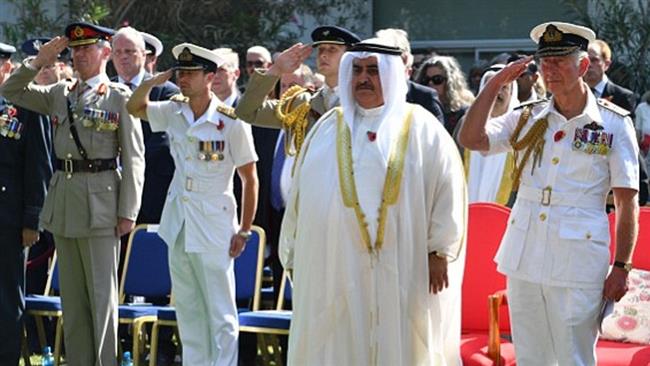 Britain’s Prince Charles (R) salutes as Bahrain’s Foreign Minister Khalid bin Ahmed Al Khalifa stands nearby during a ceremony in Manama, Bahrain, November 11, 2016