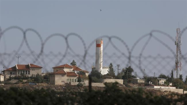 This October, 28 2016, photo shows the illegal Israeli settlement of Bait Hagay through a barbed wire fence that secures the perimeter, south of the West Bank city of al-Khalil (Hebron). (Photo by AP)