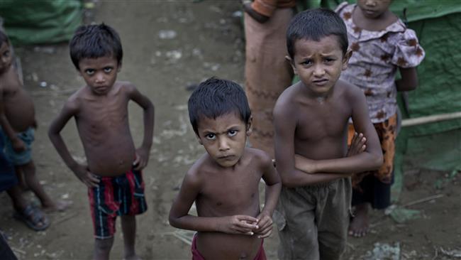 In this file photo, Rohingya children gather at a camp for Muslim refugees, north of Sittwe, western Rakhine State, Myanmar. (By AP)