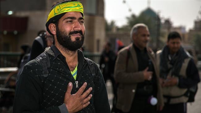 An Iranian pilgrim is seen overwhelmed with emotion upon reaching Imam Hossein’s holy 