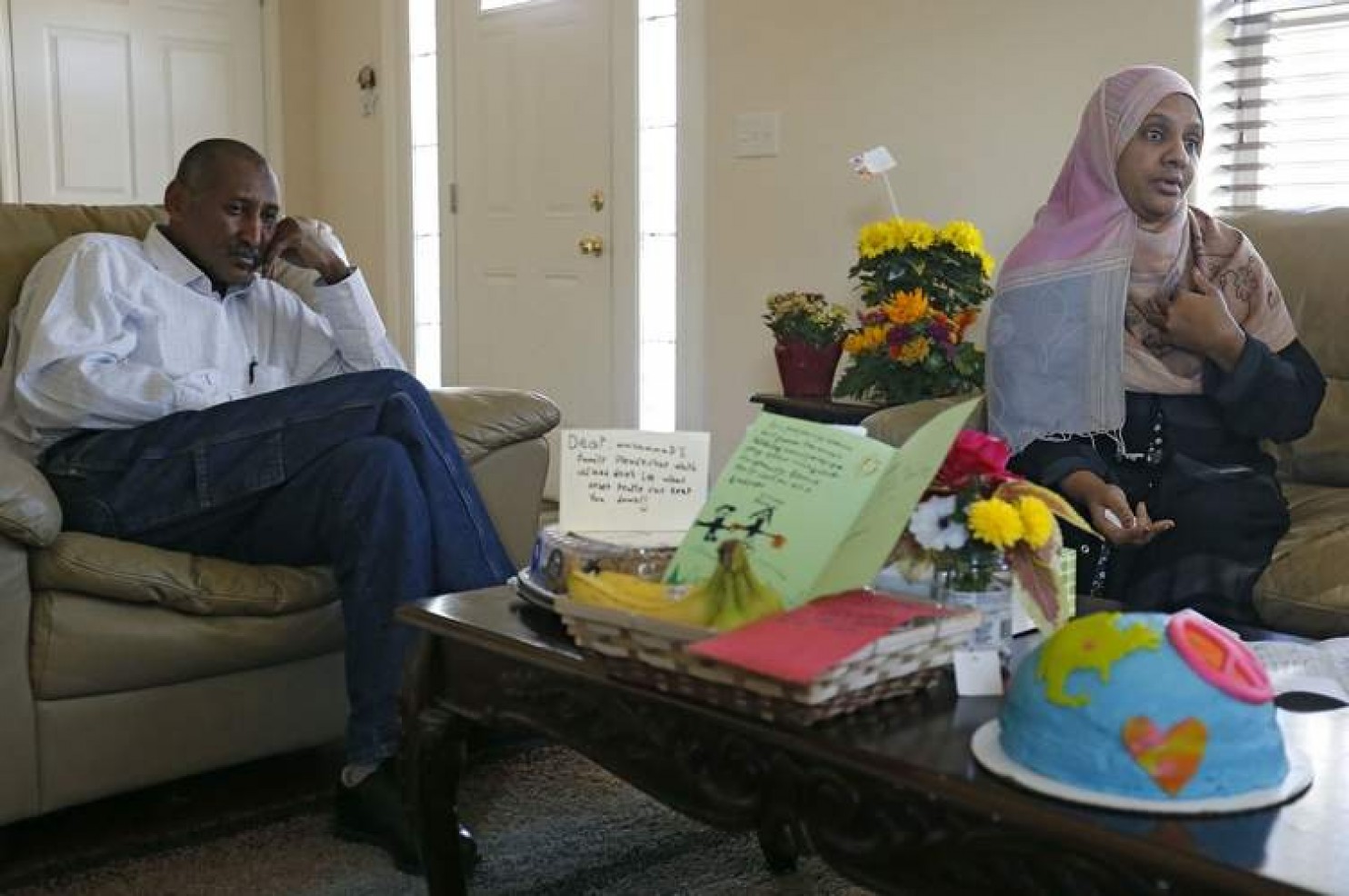 Amar Samel (left) and Muna Abdalla talk about a hate message taped to the door of their house in Iowa City 