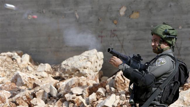 An Israeli soldier fires a teargas canister during clashes following a demonstration against the expropriation of Palestinian land by Israel in the occupied West Bank on November 18, 2016. (Photo by AFP)
