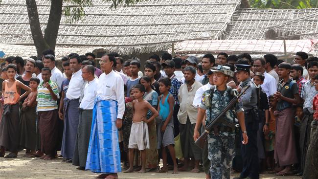 Members of the persecuted Rohingya Muslims gather for the arrival of a delegation of UN officials and foreign diplomats in Ale Than Kyaw village in Maungdaw, Myanmar