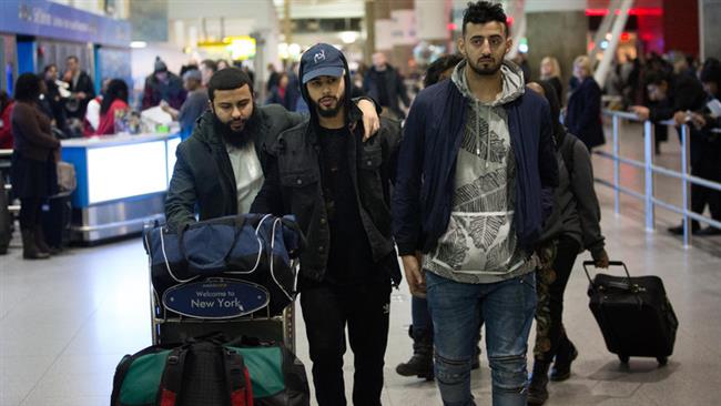 Adam Saleh, center, and Slim Albaher, right, after arriving at John F. Kennedy International Airport on Wednesday, December, 21, 2016. (Photo by The New York Times)
