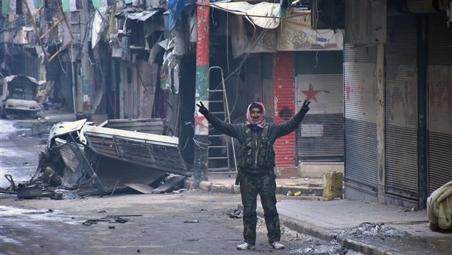 A Syrian man gestures in the Syrian city of Aleppo on December 23, 2016 after Syrian government forces retook control of the whole embattled city. (Photo by AFP)
