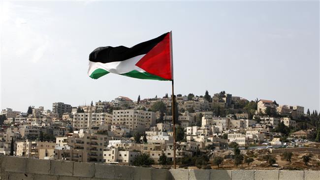 In this photo taken on October 20, 2015, a Palestinian flag flies on the roof of the temporary apartment of a Palestinian family who were evicted from their home in the Silwan neighborhood of East Jerusalem al-Quds. (Photo by AP)
