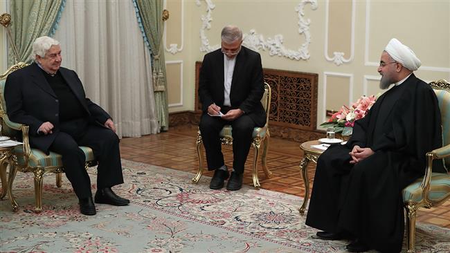 Iranian President Hassan Rouhani (R) and Syrian Foreign Minister Walid al-Muallem meet in Tehran on December 31, 2016.