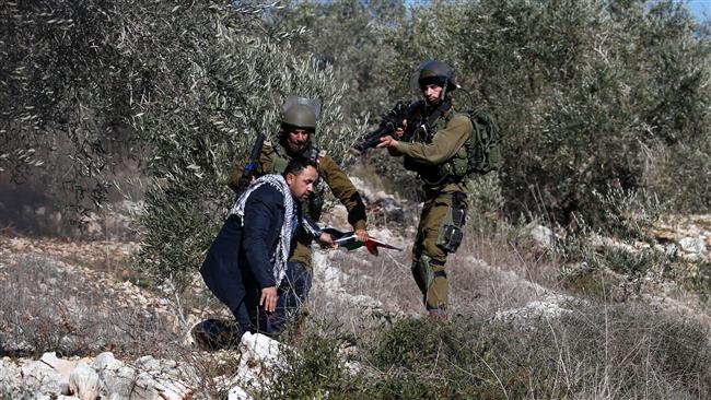 Israeli forces detain a Palestinian man following a demonstration against the expropriation of Palestinian land by Israel in the village of Kafr Qaddum, near Nablus, in the occupied West Bank on December 30, 2016. (Photo by AFP)