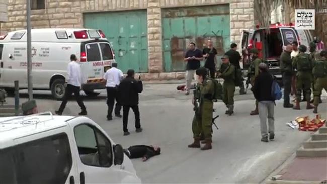 This still grabbed from video released by B’Tselem on March 24, 2016 shows an Israeli soldier aiming his weapon before shooting dead an already-subdued Palestinian man, in the West Bank city of al-Khalil (Hebron). (Photo by AFP)
