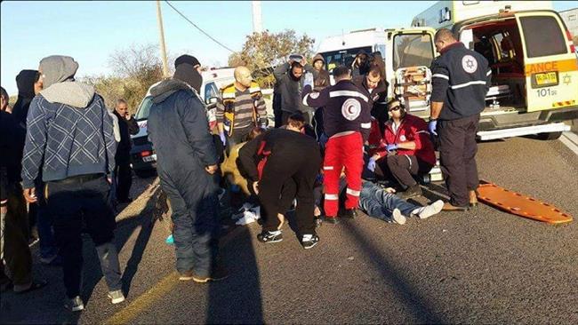 An injured Palestinian man receives treatment on the scene after being run over by an illegal Israeli settler near the occupied West Bank city of Hebron (al-Khalil) on January 6, 2017.
