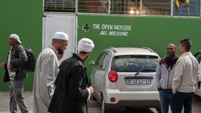 Muslim worshipers stand by at Cape Town mosque amid reports that two mosque in the city were defaced in rare Islamophobic acts in the country