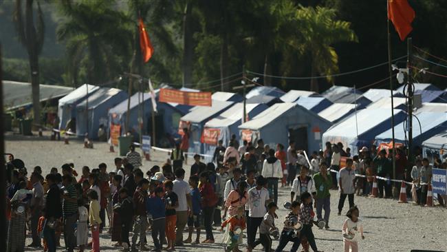 Refugees from Myanmar line up for food at a refugee camp in Wanding, in China’s southwest Yunnan Province, November 30, 2016.