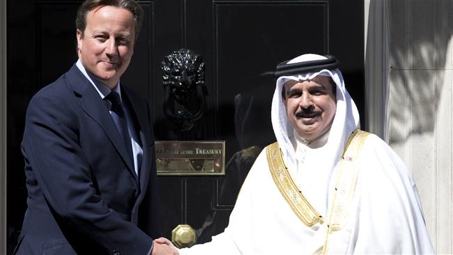 Britain’s then Prime Minister David Cameron (L) poses for a photograph with Bahrain’s King Hamad bin Isa Al Khalifah, in London, August 6, 2013.