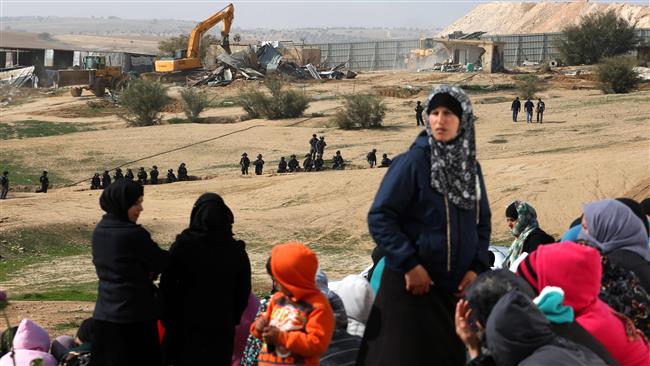 Bedouin women react to the demolition of houses in the village of Umm al-Hayran