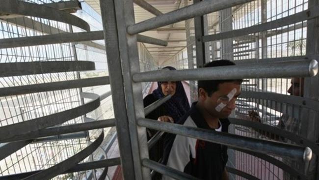 Palestinians walk through the Erez border crossing on June 9, 2010. 