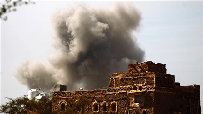 Smoke billows behind a building following an airstrike by Saudi Arabia in the Yemeni capital, Sana