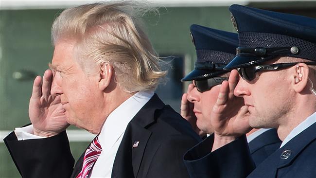 US President Donald Trump salutes as he steps off Air Force One at Andrews Air Force Base in Maryland upon his return from Philadelphia