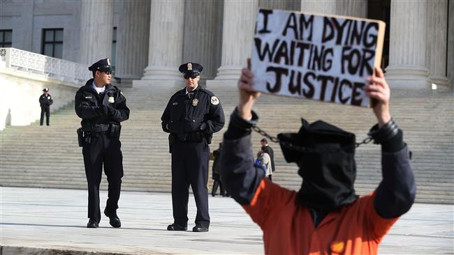 Protesters gather in front of the US Supreme Court to mark 15 years since the first prisoners were brought to the US detention facility in Guantanamo Bay, Cuba, on January 11, 2017 in Washington, DC. (Photo by AFP)

