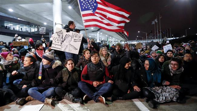 People gather to protest against the travel ban imposed by President Donald Trump