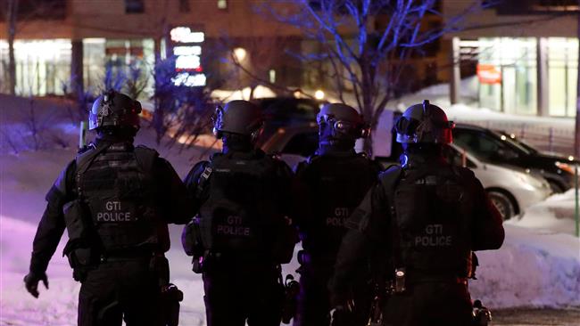 SWAT team police officers walk around the targeted mosque in Quebec City after a shooting, January 29, 2017.