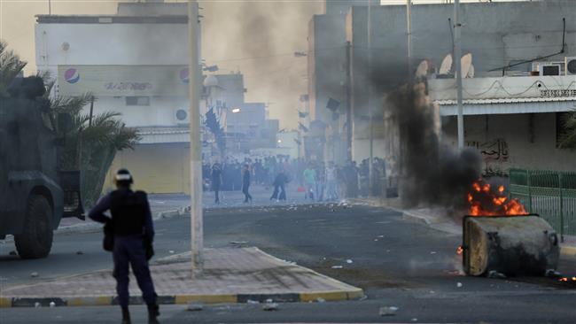 Bahraini anti-regime protesters clash with police firing tear gas in Shahrakan, Bahrain