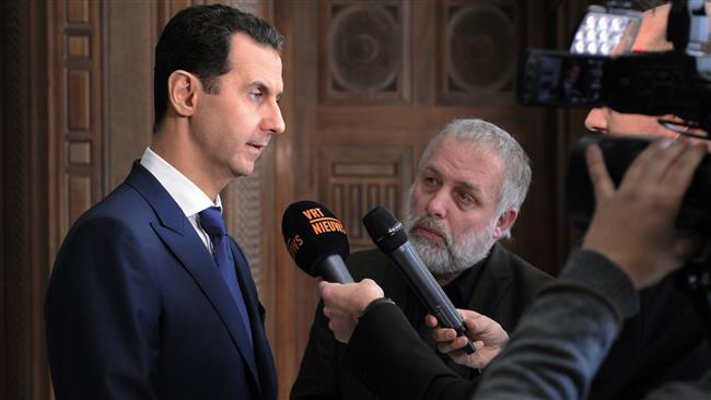 A handout picture released by SANA on February 7, 2017 shows Syrian President Bashar al-Assad (L) giving an interview to a Belgian media outlet. (Photo by AFP)