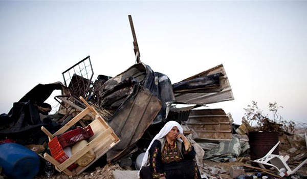 Palestinian woman in front of her house which is  demolished by Israeli Forces