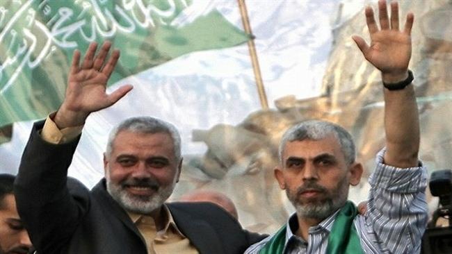 This photo taken on October 21, 2011 shows then Hamas leader Ismail Haniyah (L) and Yahya Sinwar (R), a founder of the Ezzedine Qassam Brigades, waving as supporters celebrate the release of hundreds of prisoners following a swap with captured Israeli trooper Gilad Shalit in the southern city of Khan Yunis in the Gaza Strip. (Photo by AFP)
