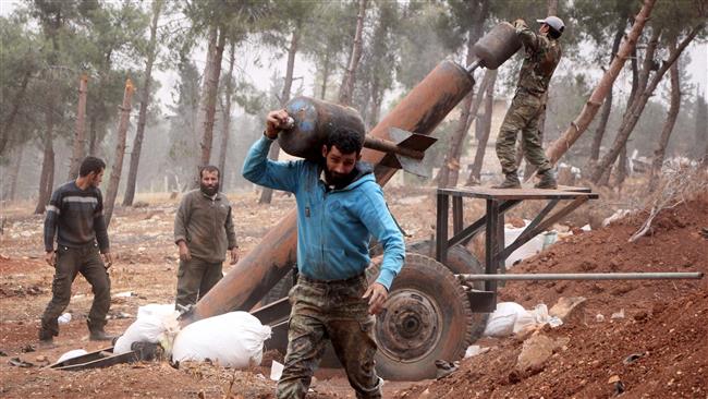 Takfiri terrorists prepare to fire a home-made mortar launcher.